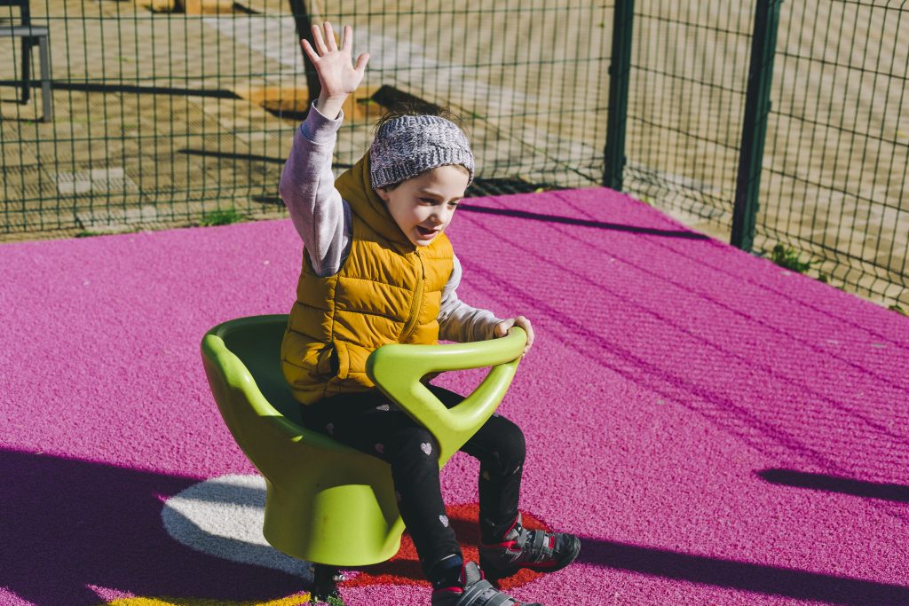 girl rocking chair park